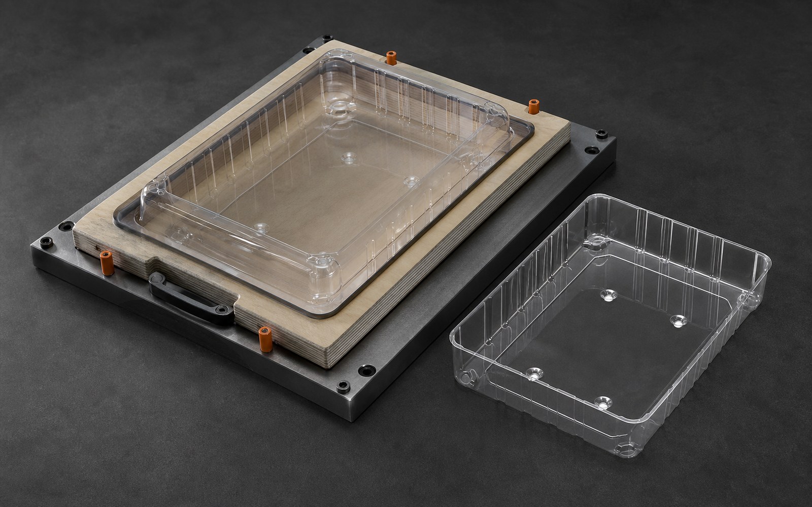 Clear thermoformed PET part seated in a trim cutting die