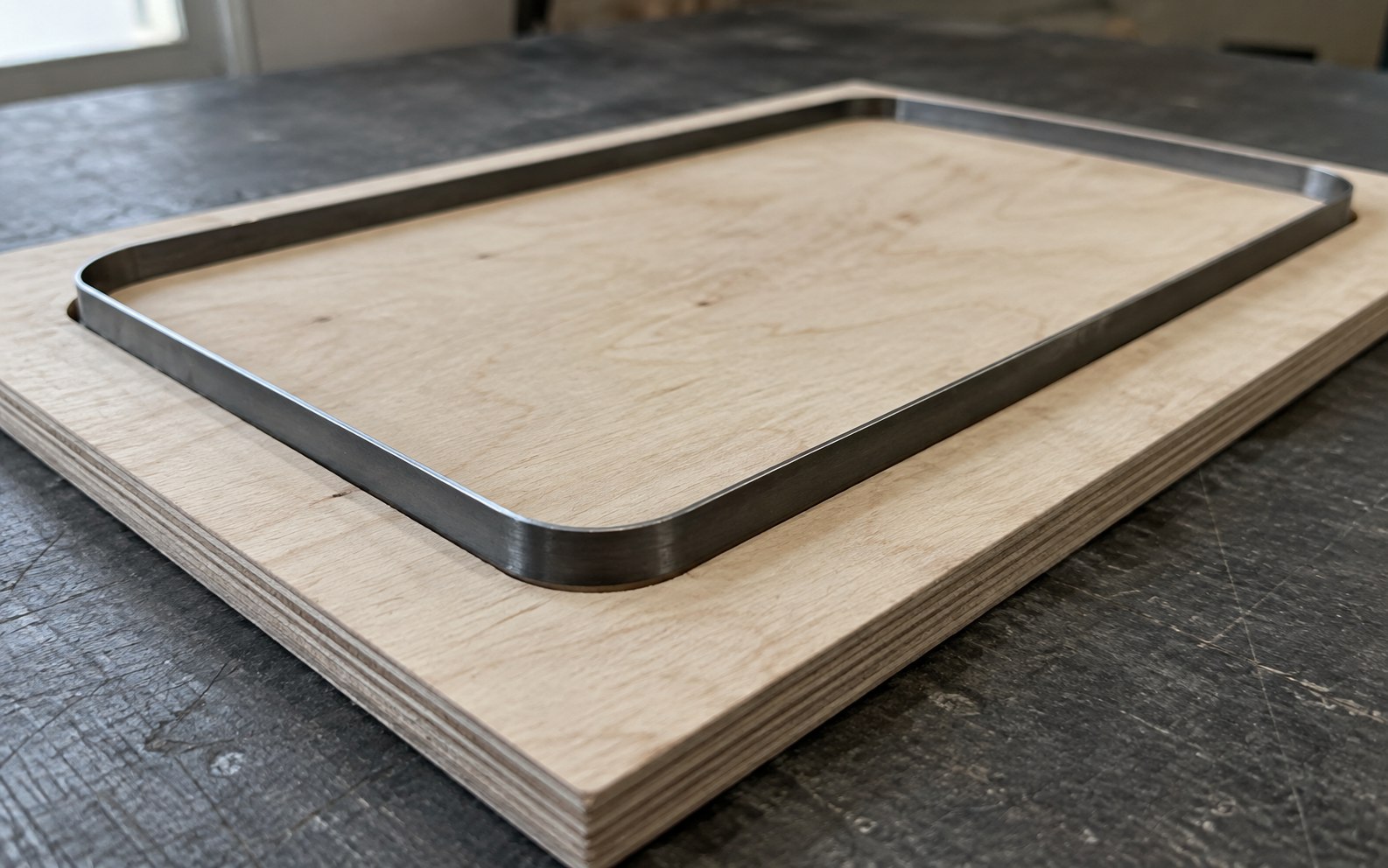Close-up of a steel cutting rule seated in a plywood die board